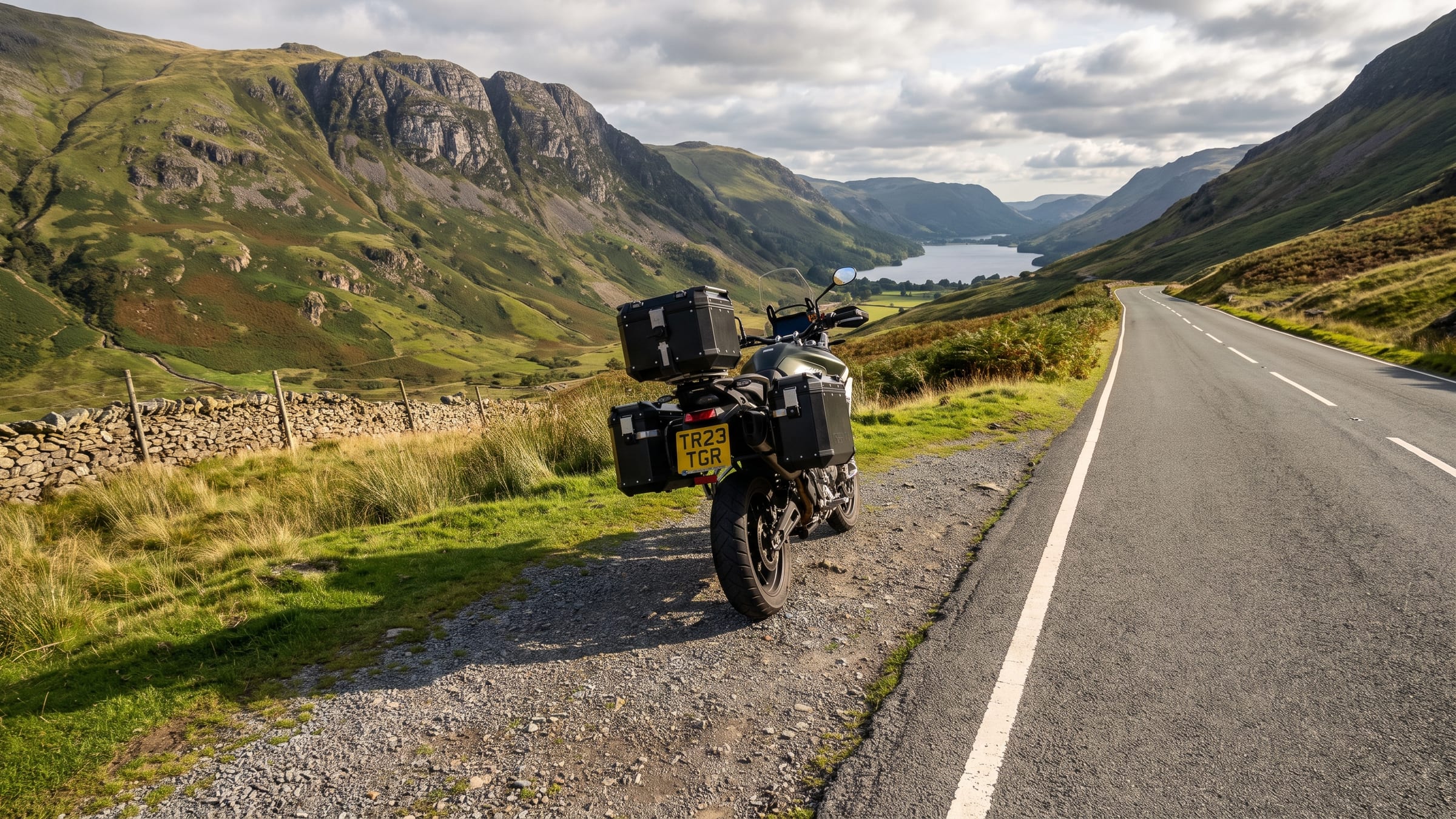 A motorcycle in a lay-by on a Lake District pass, a lake in the valley below