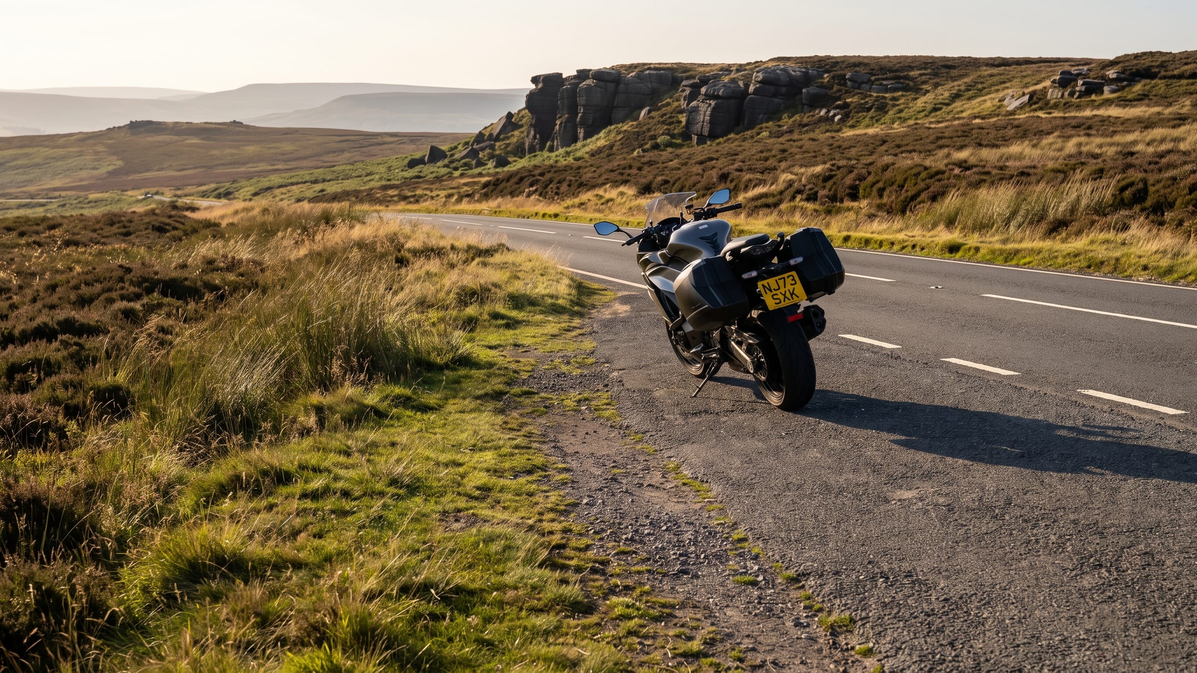 A moorland road below a gritstone edge in the Peak District