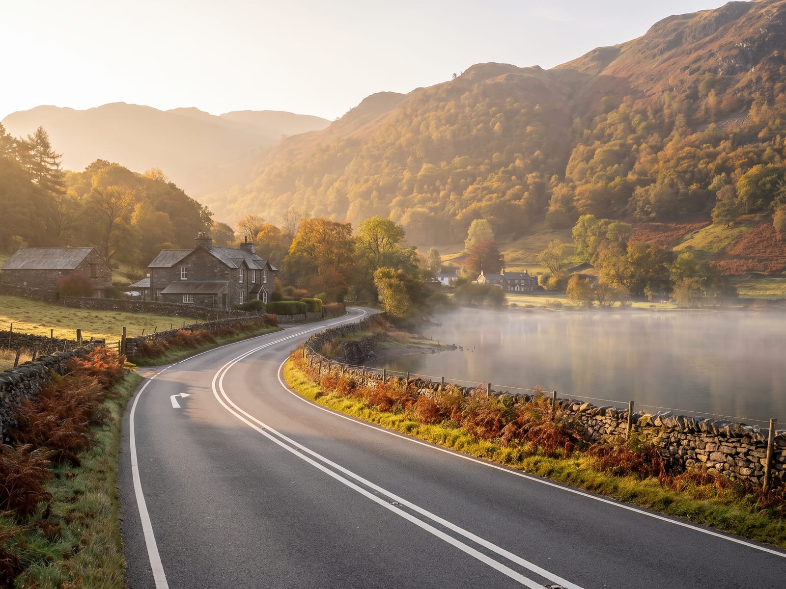 Near Ambleside: a smooth two-lane road running beside a long still lake in the Lake District, Cumbria