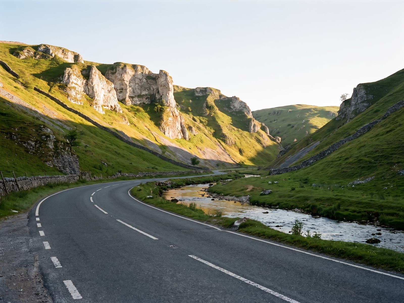 Near Buxton: a tarmac road running through a steep-sided limestone dale in the White Peak, Derbyshire